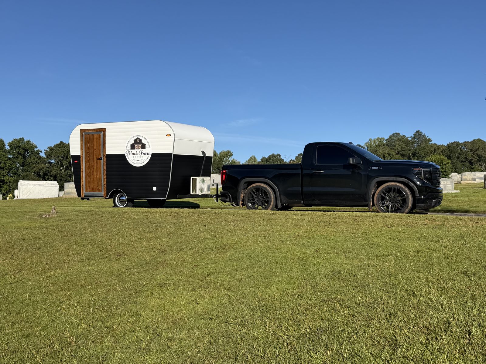 Black Barn Bakery canned-ham trailer hitched to a black pickup