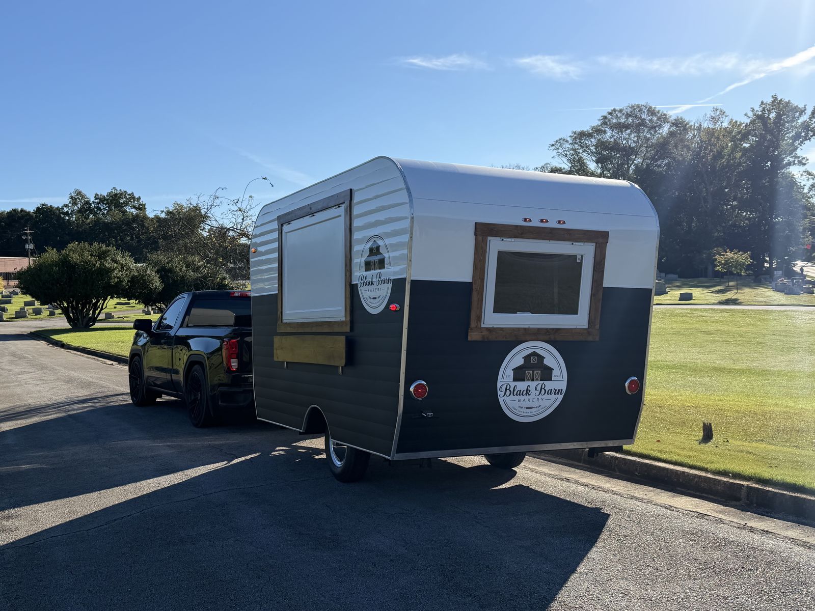 Black Barn Bakery trailer with the wood-framed service window open