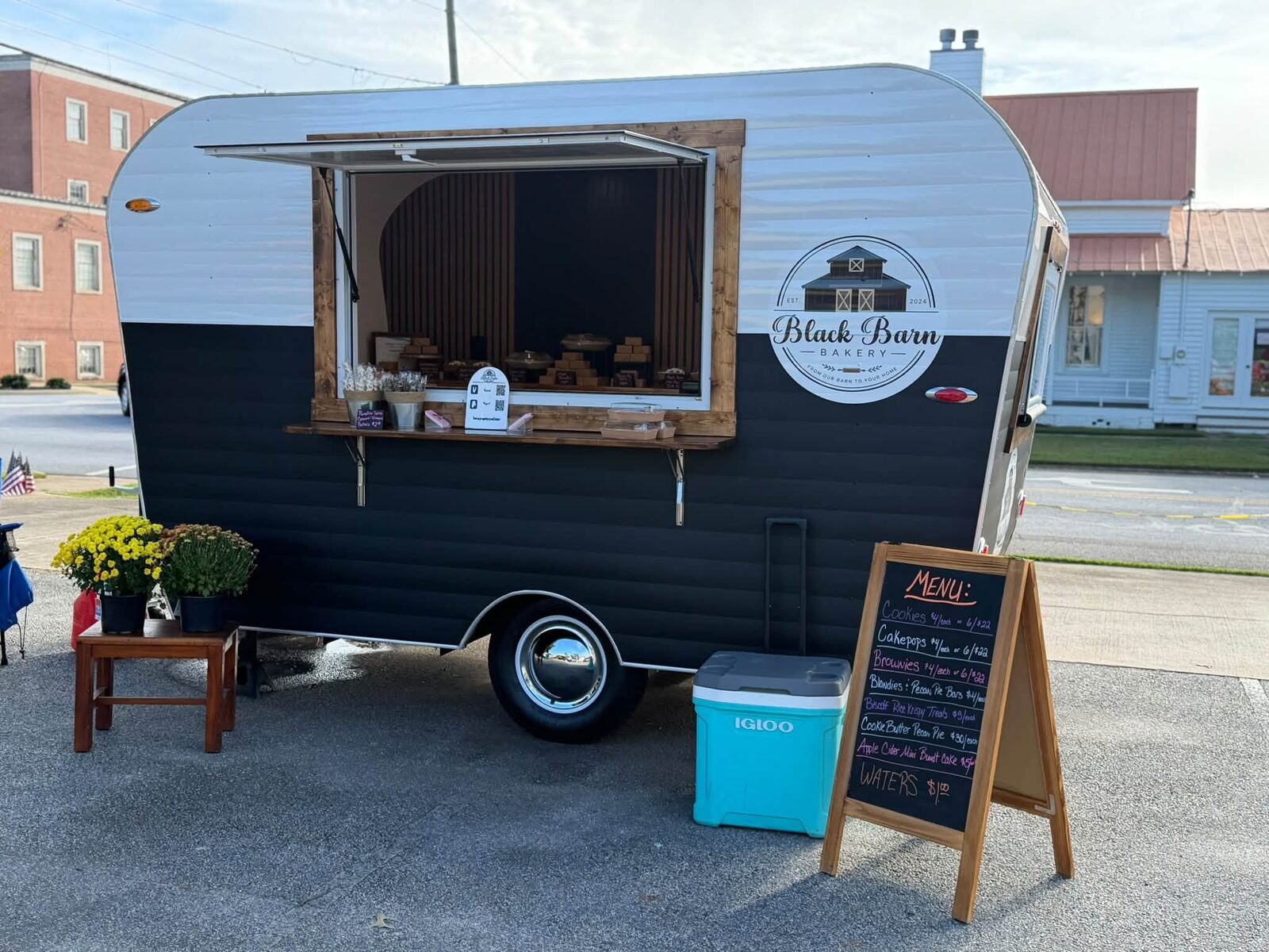 Black Barn Bakery white-over-black trailer on the street with the service window open