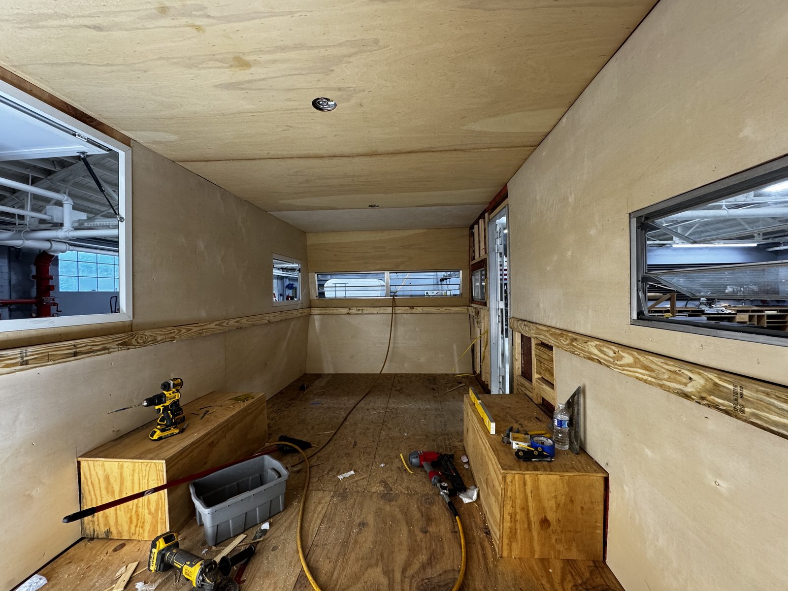 Plywood-lined trailer interior looking toward the open service window