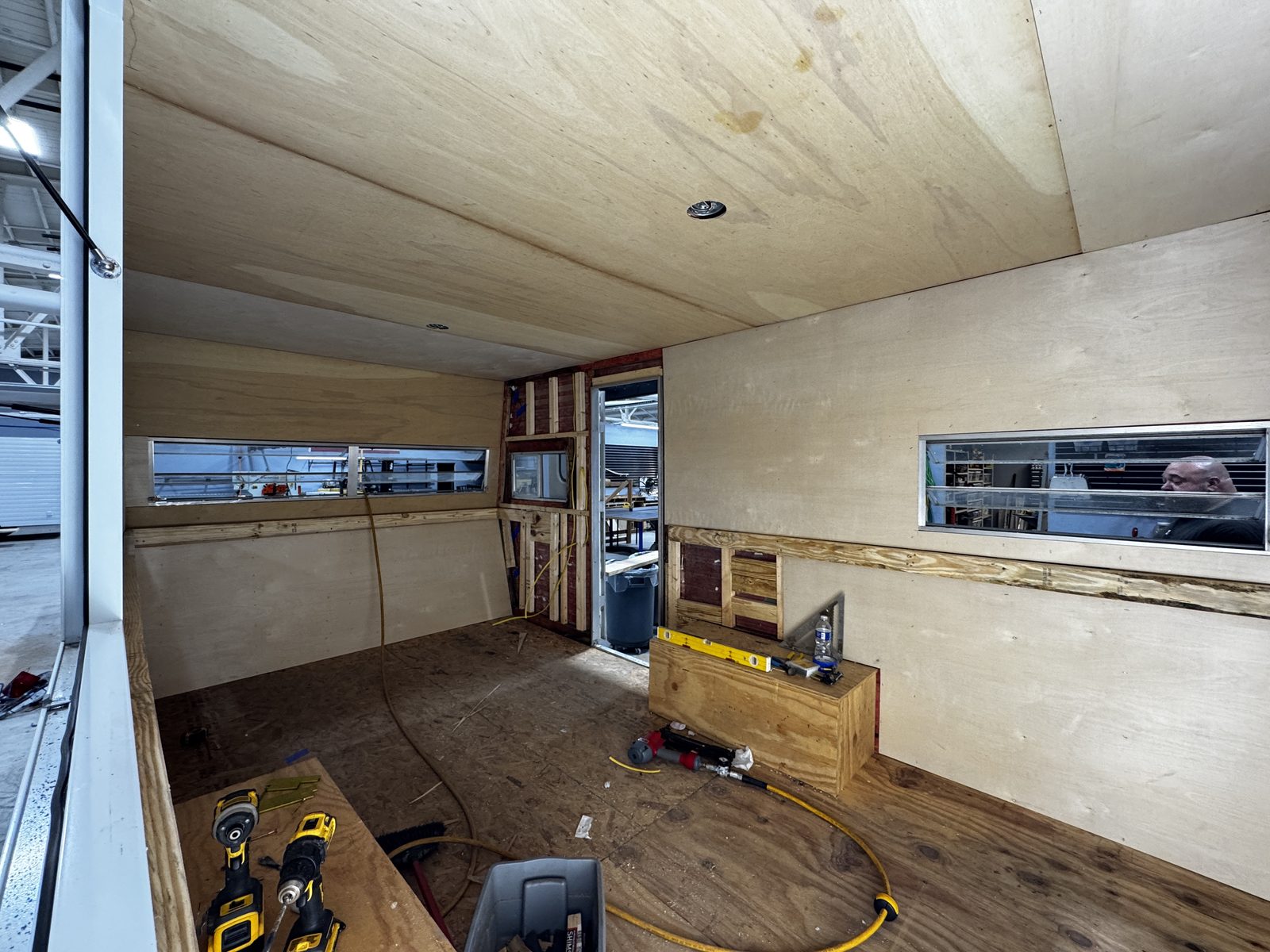 Plywood-lined trailer interior looking toward the entry door