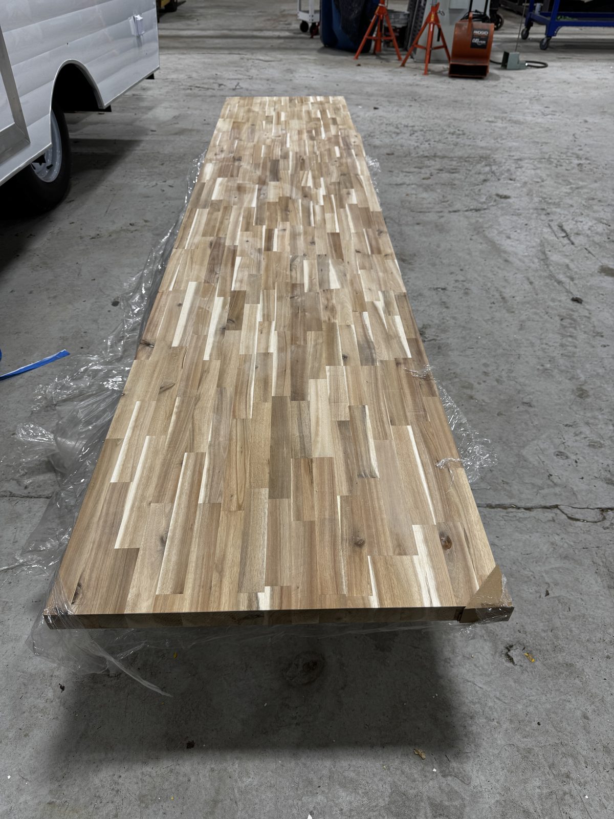 Long butcher-block countertop on the shop floor